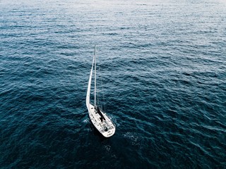 Aerial view of sailing ship yacht at deep open sea.