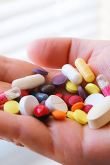 Biologically active additive. Handful of pills in his hand. Pharmacology of shadow production. Placebo. The problem of counterfeit drugs.