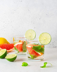 Glass of cool infused water with fresh grapefruit, lime and mint, (lemonade, cocktail). Detox drink, health care, fitness, diet concept.