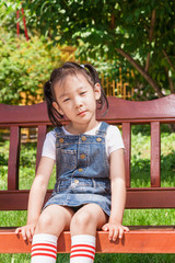 Chinese girls sitting in courtyard chairs in summer