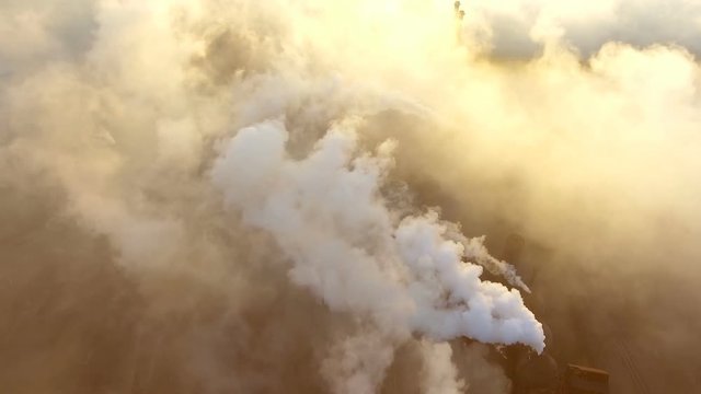 Emission to atmosphere from industrial pipes. Smokestack pipe shooted with drone