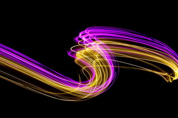 Long exposure light painting photography, curvy lines of vibrant neon pink and metallic yellow gold against a black background