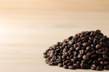 roasted coffee beans on a natural wooden table. Frame of coffee beans Robusta, Arabica. space for text