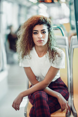 Arab woman inside metro train. Arab girl in casual clothes.