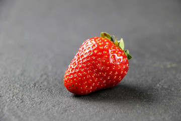 fresh strawberries on gray background