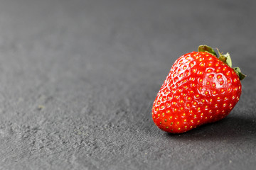 fresh strawberries on gray background