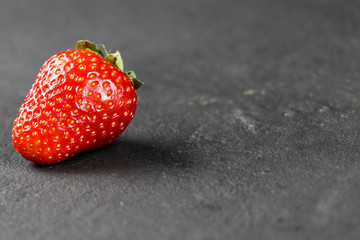 fresh strawberries on gray background