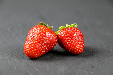fresh strawberries on gray background