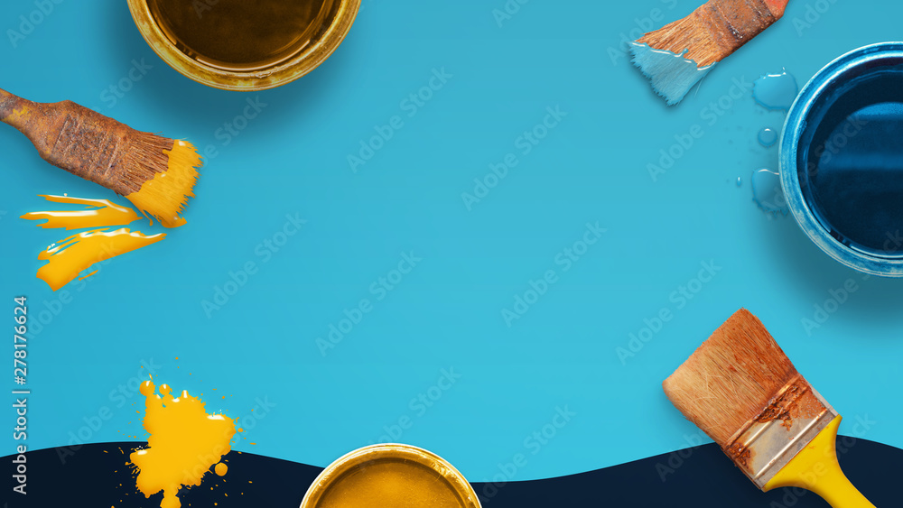 Poster painting concept composition with brushes and color boxes on blue desk. copy space in the middle for