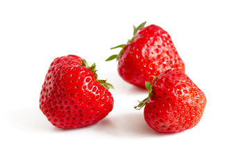 Three ripe strawberries isolated on white