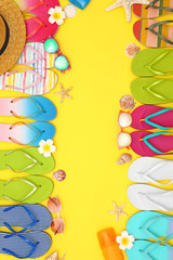 Flat lay composition with summer beach accessories on yellow background. Space for text