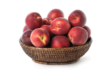 Basket of delicious ripe peaches isolated on white