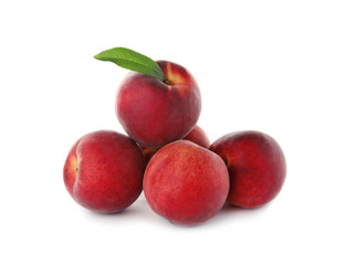 Delicious ripe peaches with leaf isolated on white
