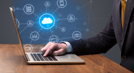 Businessman hand typing with cloud technology system and office symbol concept