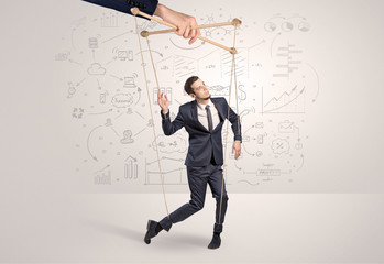 Little businessman controlled from above like a puppet concept