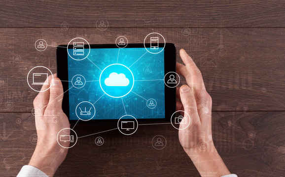 Hand touching tablet with cloud computing and online storage concept