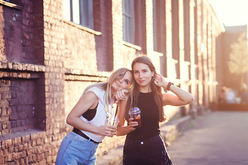 Fototapeta premium two funny girls in shorts posing on the street