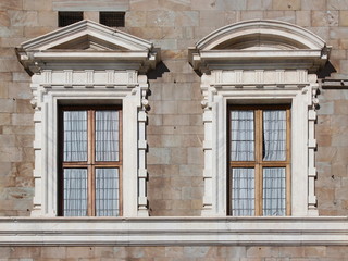 Obraz premium Two mannerist windows topped by a pediment at Palazzo alla Giornata in Pisa, Italy