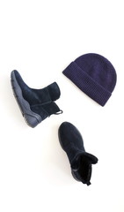 Women fashion clothes and accessories top view. Flat lay female autumn style look with  hut, sneakers boots blue color on white background. copy space