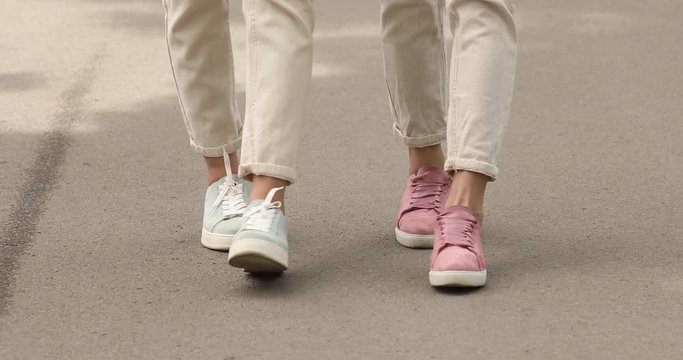 Two happy women walking on camera.