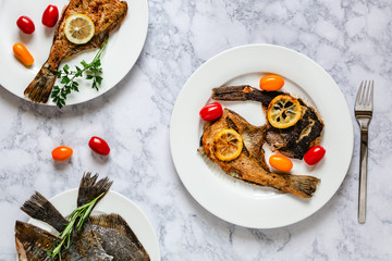 Grilled flounder fish served on white plate