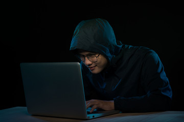 Computer hacker working in dark room