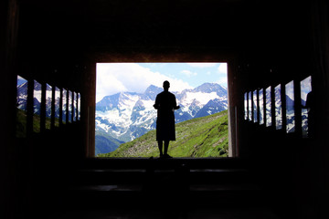 silhouette of a woman looking at a mountain panorama