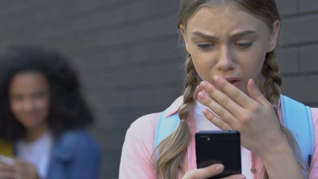 Girl upset by negative comments in social network, peers mocking, cyberbullying
