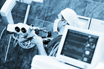 surgical microscope on the background of modern neurosurgical operating room and doctors