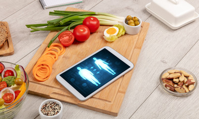 Arrangement of healthy Ingredients with a tablet. Dieting concept