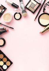 Makeup products, decorative cosmetics on pink background  flat lay toned.  Fashion and beauty concept. Top view. Copy space.