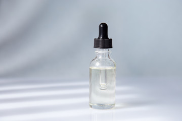 Naklejka premium Dropper glass bottle with pipette. Mock up Essential liquid .