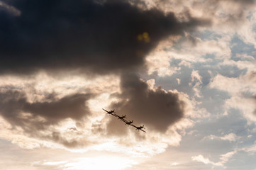 Aerobatics planes flying in the sky with clouds in the background