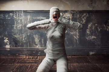 mummy screams in horror and tears the bandages. The girl with the bandage.