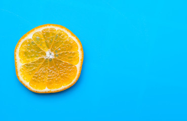 Summer of slice orange fruit on blue background.