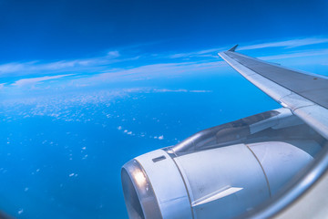 white cloud in blue sky looking from the plane window