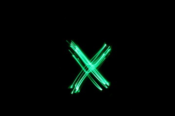 Long exposure photograph, light painting photography.  Letter x of an alphabet series, single...