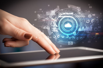 Hand holding tablet with cloud storage technology concept