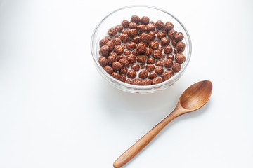 chocolate corn flakes in a bowl isolated on white