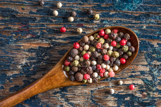 Multi colored Peppercorns on a Wood Spoon