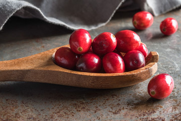 Whole Cranberries on a Wood Spoon