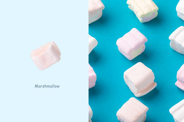 Creative layout made of sweet marshmallows on blue background. Minimalism concept
