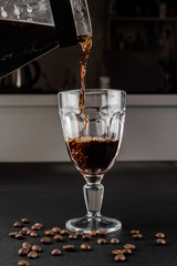 Alternative method of making coffee. coffeemaker is a manual pour-over style glass. Cofee brewing on black background