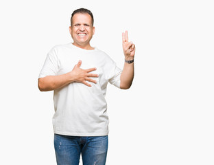 Middle age arab man wearig white t-shirt over isolated background Swearing with hand on chest and...