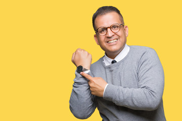 Middle age bussines arab man wearing glasses over isolated background In hurry pointing to watch...