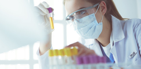 Researcher, doctor, scientist or laboratory assistant working with plastic medical tubes in modern...