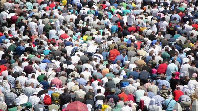Crowds of Muslims pray. Men at Friday prayer in mosque in Ramadan. Muslim pilgrims and worshipers. Muslims praying in open space. Concept: God, religion, Islam, Quran, Ramadan, namaz, worship, faith