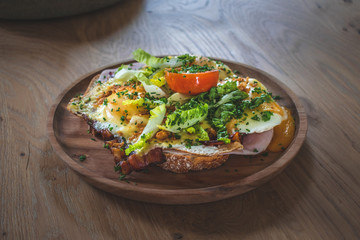 Delicious sandwich with ham, cheese, bacon, fried egg and tomato a typical Dutch lunch dish