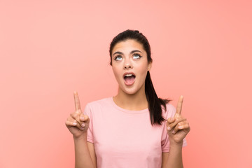 Teenager girl over isolated pink background pointing with the index finger a great idea