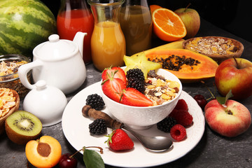 Healthy breakfast. Bowl of yogurt with granola and berries, fresh fruits and smootihies